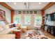 Bright living room with wood beams, concrete floors, a comfortable sectional, and natural light at 117 Elati St # 1, Denver, CO 80223