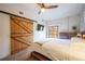 Bright bedroom with ceiling fan, wooden sliding door and dresser with balcony access at 117 Elati St # 1, Denver, CO 80223