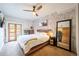 Bright main bedroom boasts a ceiling fan, balcony access, and stylish rustic accents at 117 Elati St # 1, Denver, CO 80223