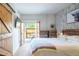 Main bedroom with private balcony, decorative barn door, and modern furniture at 117 Elati St # 1, Denver, CO 80223