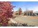 Street view of well-maintained brick buildings with blooming trees and a clear blue sky at 117 Elati St # 1, Denver, CO 80223