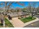 Charming home with a well-manicured front lawn, long driveway, and attached garage nestled among mature trees at 6773 E Baker Pl, Denver, CO 80224