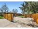 Large backyard with a wooden fence and mature trees, offering privacy and space for outdoor activities at 6773 E Baker Pl, Denver, CO 80224