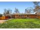 Expansive backyard featuring a well-maintained lawn and mature trees, perfect for outdoor activities and relaxation at 6773 E Baker Pl, Denver, CO 80224