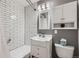 Bathroom featuring modern fixtures, subway tile, gray walls, toilet, vanity, shower and tub at 6773 E Baker Pl, Denver, CO 80224