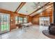Sunlit dining area with a wood paneled walls, tile floors, and sliding door access to outside at 6773 E Baker Pl, Denver, CO 80224
