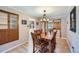 Cozy dining room featuring hardwood floors, wood table, and stylish lighting at 6773 E Baker Pl, Denver, CO 80224
