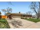 Beautiful home with a brick exterior, lush green lawn, and a two-car garage at 6773 E Baker Pl, Denver, CO 80224