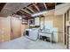 Functional laundry room with washer, dryer, sink, and shelving, offering convenience for laundry tasks at 6773 E Baker Pl, Denver, CO 80224