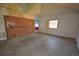 Spacious room with potential, featuring exposed brick and natural light from the window at 6773 E Baker Pl, Denver, CO 80224