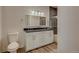 Double vanity bathroom with gray tile and a frameless shower at 14936 E Hampden Ave # 202, Aurora, CO 80014