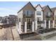 Two-story townhome boasts a gray exterior, private balconies, and fenced patio at 10876 Lyric St, Lone Tree, CO 80134