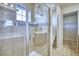 Bathroom featuring glass enclosed shower, decorative tile, and neutral walls at 899 Winding Brook Dr, Berthoud, CO 80513