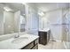 Bathroom featuring double sinks with modern fixtures and a glass enclosed shower at 899 Winding Brook Dr, Berthoud, CO 80513