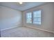 Bedroom featuring neutral walls, carpet, and natural light from two windows at 899 Winding Brook Dr, Berthoud, CO 80513