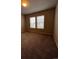 Spacious carpeted bedroom with dual windows, offering natural light and comfort at 899 Winding Brook Dr, Berthoud, CO 80513