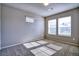 Neutral bedroom with two windows, offering ample natural light over plush carpeting at 899 Winding Brook Dr, Berthoud, CO 80513