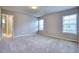 Spacious bedroom with plush carpeting, natural light, and an en-suite bath at 899 Winding Brook Dr, Berthoud, CO 80513