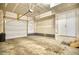 Spacious unfinished garage with concrete floor, ample lighting, and garage door at 899 Winding Brook Dr, Berthoud, CO 80513