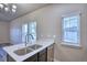 Kitchen with stainless steel sink, bright countertops and windows offering great natural light at 899 Winding Brook Dr, Berthoud, CO 80513