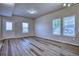 Living room with wood-style flooring, neutral walls, and multiple windows for natural light at 899 Winding Brook Dr, Berthoud, CO 80513