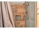 Nicely tiled shower featuring a shower niche and gray shower curtain at 7801 W 35Th Ave # 1, Wheat Ridge, CO 80033