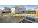 Wide view of the backyard, featuring a lawn and patio with a grill at 2311 Horse Shoe Cir, Fort Lupton, CO 80621