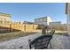 View of the fenced backyard featuring a brick patio, grill, and lawn at 2311 Horse Shoe Cir, Fort Lupton, CO 80621