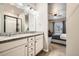 This bathroom features dual sinks, granite countertops, and is attached to the bedroom at 2311 Horse Shoe Cir, Fort Lupton, CO 80621