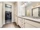 This bathroom features dual sinks, granite countertops, and a walk in closet for convenience and comfort at 2311 Horse Shoe Cir, Fort Lupton, CO 80621