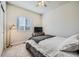 This bedroom features a comfortable bed, a tv, and natural lighting from the window at 2311 Horse Shoe Cir, Fort Lupton, CO 80621