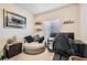 This bedroom features a couch, desk, and leopard print decor, making it the perfect place to relax and play at 2311 Horse Shoe Cir, Fort Lupton, CO 80621