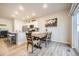 Well lit Dining area features seating for four and is located adjacent to the modern kitchen with wood grain flooring at 2311 Horse Shoe Cir, Fort Lupton, CO 80621