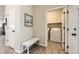 This hallway features a bench and laundry room with a washer and dryer at 2311 Horse Shoe Cir, Fort Lupton, CO 80621