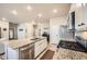 Bright open kitchen featuring an oversized island with granite countertops, stainless steel appliances, and a gas range at 2311 Horse Shoe Cir, Fort Lupton, CO 80621