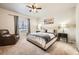 This serene bedroom features a plush bed, cozy armchair, and soft, neutral colors, creating a relaxing retreat at 2311 Horse Shoe Cir, Fort Lupton, CO 80621