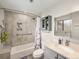 Updated bathroom with tiled shower, modern fixtures, and ample lighting at 7105 Dover Way, Arvada, CO 80004