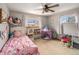 Charming bedroom with a unicorn theme, play area and plenty of natural light at 7105 Dover Way, Arvada, CO 80004