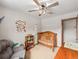 Cozy bedroom featuring neutral walls, a ceiling fan, and a wooden crib, perfect for a Bedroom at 7105 Dover Way, Arvada, CO 80004