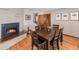 Dining room with a fireplace, wood floors, and seating for six, perfect for Gathering gatherings at 7105 Dover Way, Arvada, CO 80004