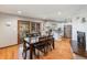 Open dining area with a fireplace, wood floors, and modern kitchen, ideal for entertaining guests at 7105 Dover Way, Arvada, CO 80004