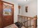 Welcoming foyer with a decorative front door and staircase, showcasing stylish interior design at 7105 Dover Way, Arvada, CO 80004