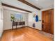 Entryway featuring wood floors, large window, coat rack, and wooden door, creating a welcoming space at 7105 Dover Way, Arvada, CO 80004