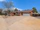 Charming red brick home with a spacious driveway and a two-car garage, perfect for Gathering living at 7105 Dover Way, Arvada, CO 80004