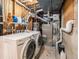 Functional laundry room with a modern washer and dryer set and a wall-mounted furnace at 7105 Dover Way, Arvada, CO 80004