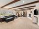 Bright living room featuring exposed wood beam ceilings, a fireplace, and a large picture window at 7105 Dover Way, Arvada, CO 80004