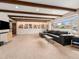 Spacious living room with custom built-in shelving, modern media center, and large picture window at 7105 Dover Way, Arvada, CO 80004