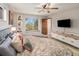 Comfortable bedroom featuring a large bed, closet and a large picture window at 7105 Dover Way, Arvada, CO 80004