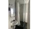 Modern bathroom featuring a glass-enclosed shower with black tiling and a pedestal sink at 422 E 6Th Ave, Denver, CO 80203