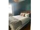 Cozy bedroom with dark green walls, comfortable bed, and soft natural light at 422 E 6Th Ave, Denver, CO 80203